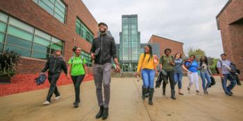 students walking in front of campus building