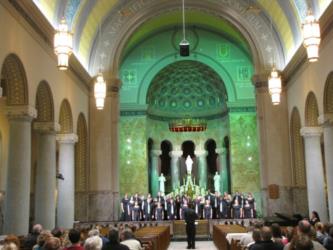 choir performing in a chapel with audience watching