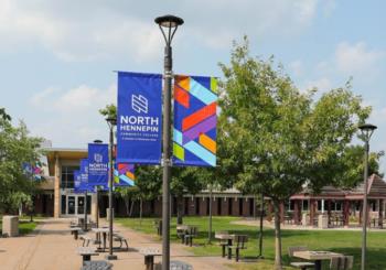 campus walkway with colorful banners reading 'NORTH HENNEPIN'