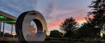 sculpture with sunset sky in the background