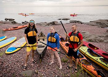 students with kayaks by the lakeside