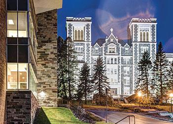 illuminated stone building at dusk