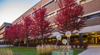 campus building with red-leafed trees