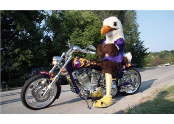 mascot on a motorcycle at a campus event