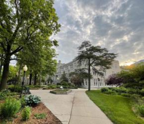 path leading to a traditional campus building at dawn