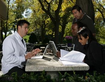 outdoor student meeting with laptops on campus