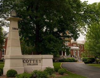 cottey college sign with lush trees and building