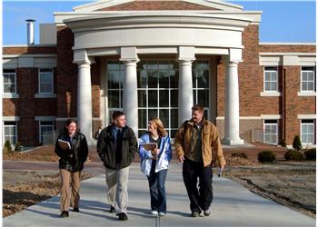 students walking in front of campus building