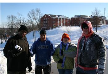 students in winter clothing with snow