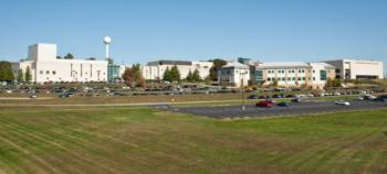 panoramic view of a campus with parking and buildings