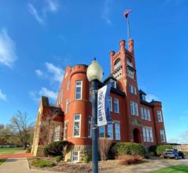 brick building with tower under blue sky