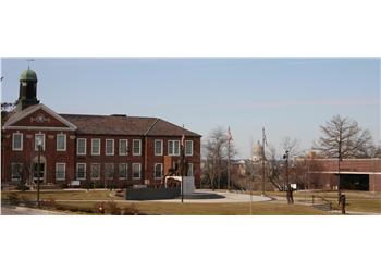 wide shot of a campus building with a green dome