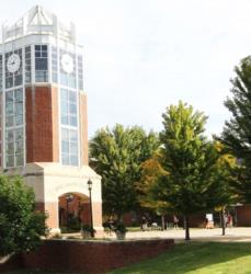 clock tower building with trees on a sunny day