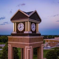 a clock tower at dusk with a clear sky