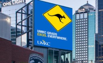 billboard with 'UMKC GRADS EXCEL EVERYWHERE' and kangaroo logo