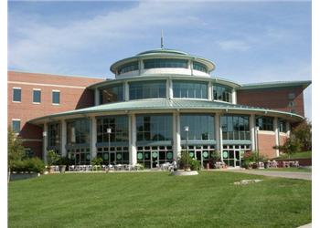 modern building with a glass facade and lawn chairs outside