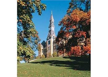 historic building with a spire among autumn trees