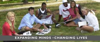 students on grass with text 'expanding minds - changing lives'