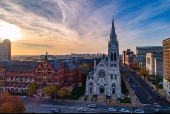 aerial view of a church and campus buildings at sunset