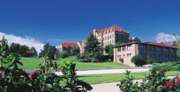 sunny campus view with buildings and green lawns