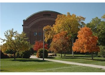 brick building with autumn trees