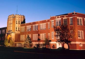 twilight view of a historic red brick university building