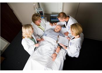 medical team discussing over patient in bed