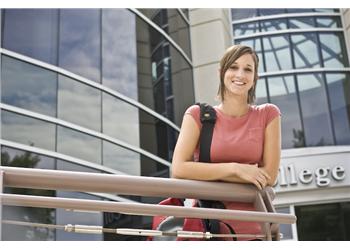 woman smiling outside college building