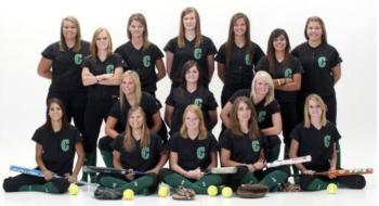 women's sports team posing with equipment