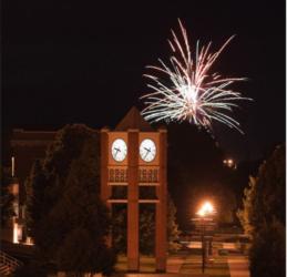 fireworks above a clock tower at night