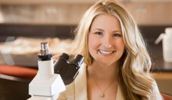 smiling person with a microscope