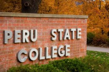 signage 'PERU STATE COLLEGE' with autumn leaves in background