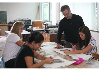 art class with instructor and students drawing