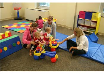 children playing with toys on colorful mats