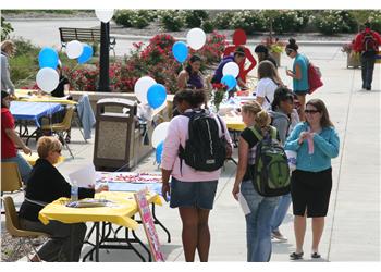 outdoor student event with informational tables