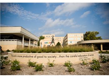 college quote on wall with building in background