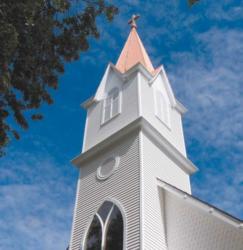 white church steeple against a blue sky