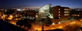 nighttime view of illuminated campus buildings and roads