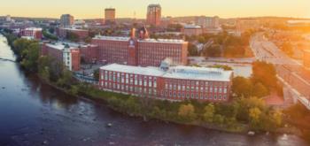 aerial view of a riverside campus at sunset