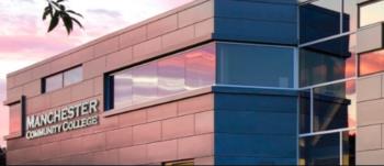 building with 'manchester community college' sign at dusk