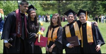 group of graduates smiling outdoors