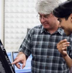 teacher assisting student with equipment