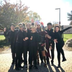 students in costumes posing outside