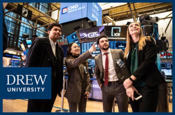 students at a stock exchange with 'drew university' logo