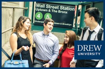 students conversing outside Wall Street Station with 'drew university' logo