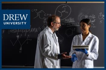 two people having a discussion in a lab with 'drew university' logo