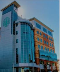 modern campus building with clock and logo