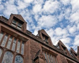 angled view of a historic building under a cloudy sky