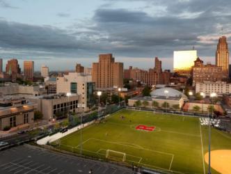 aerial view of a sports field with 'rutgers' logo at dusk