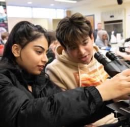 two students working with a microscope